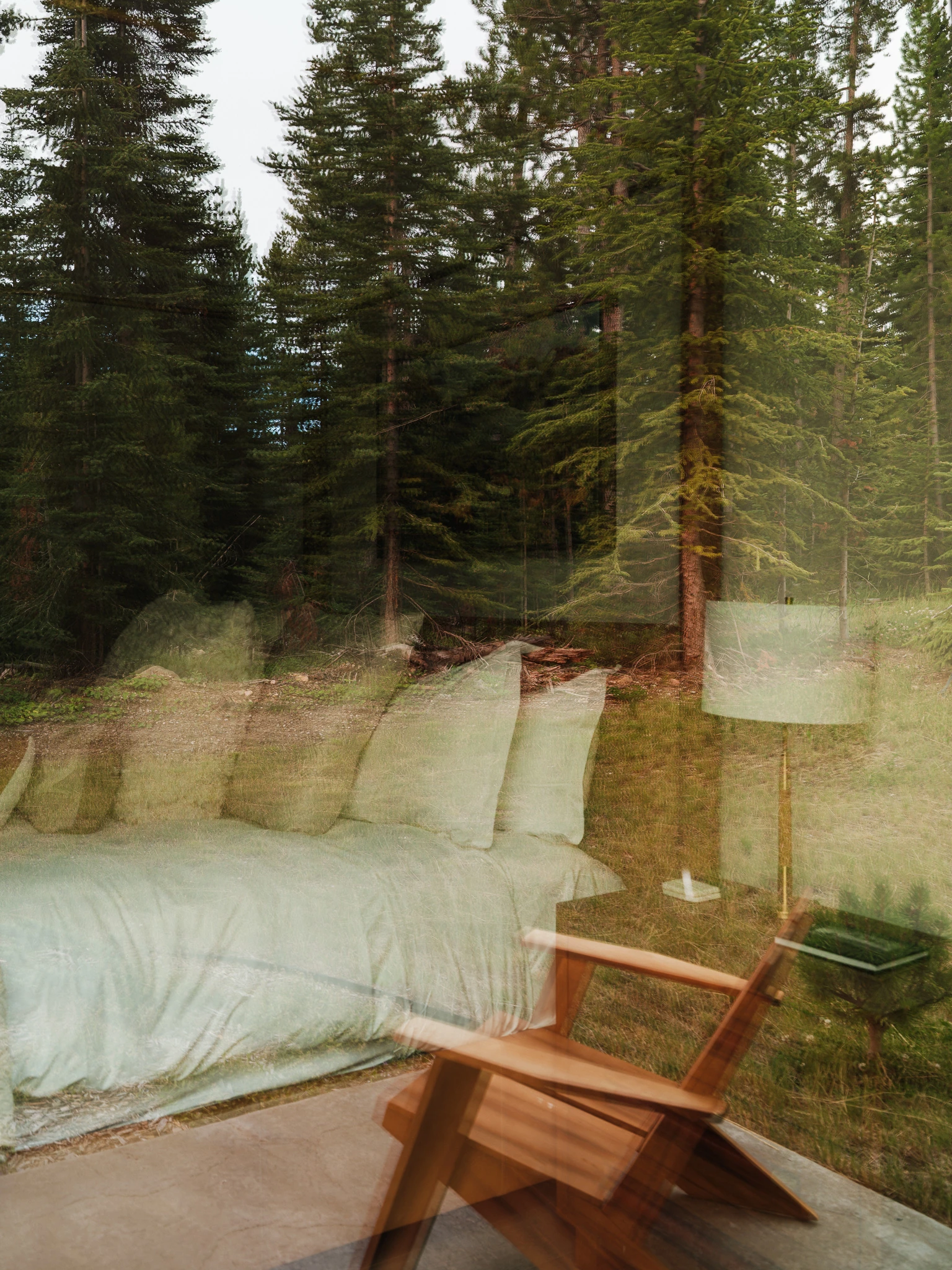 Daybed nook framed by forest views — interior design photography Big Sky Montana, Speedwell Cabin